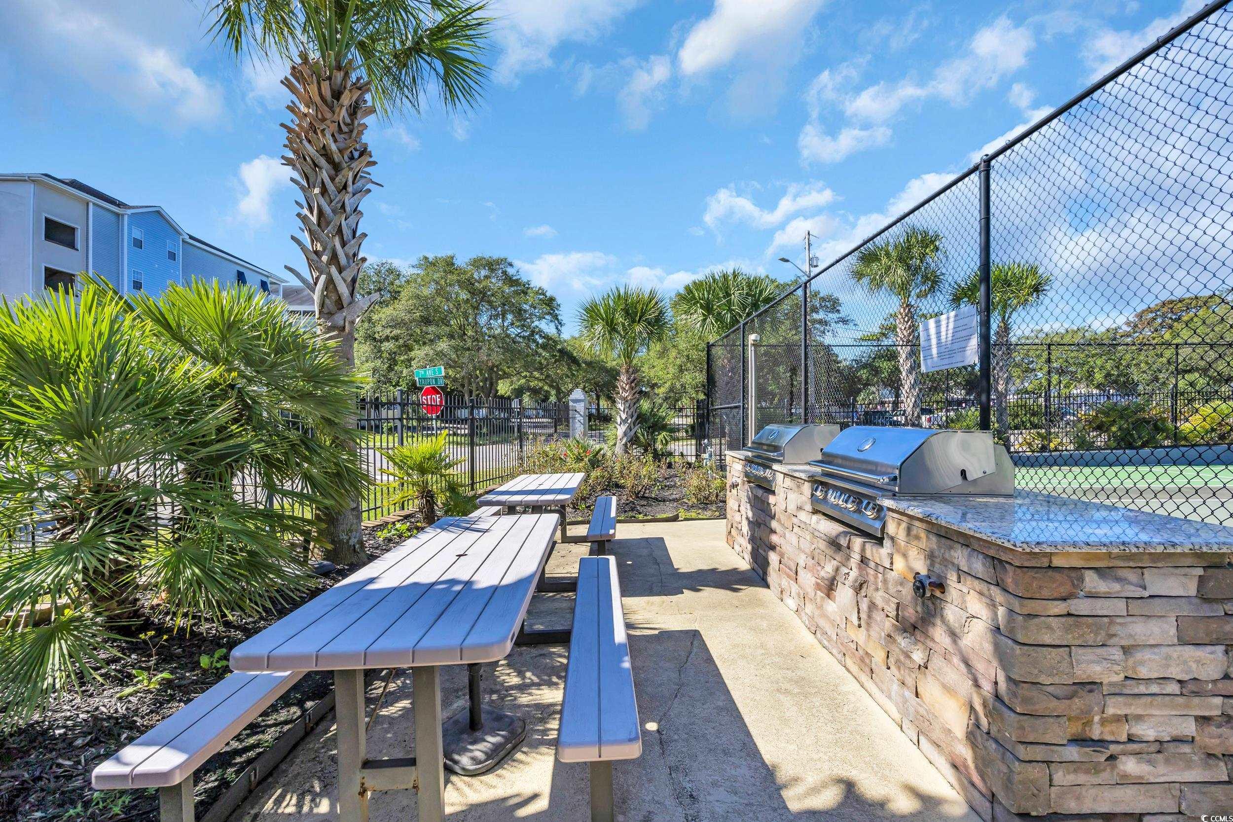 601 Mitchell Drive, Unit 203 Myrtle Beach, SC 29577 - Photo 34 of 40 View of patio / terrace with exterior kitchen and outdoor dining area