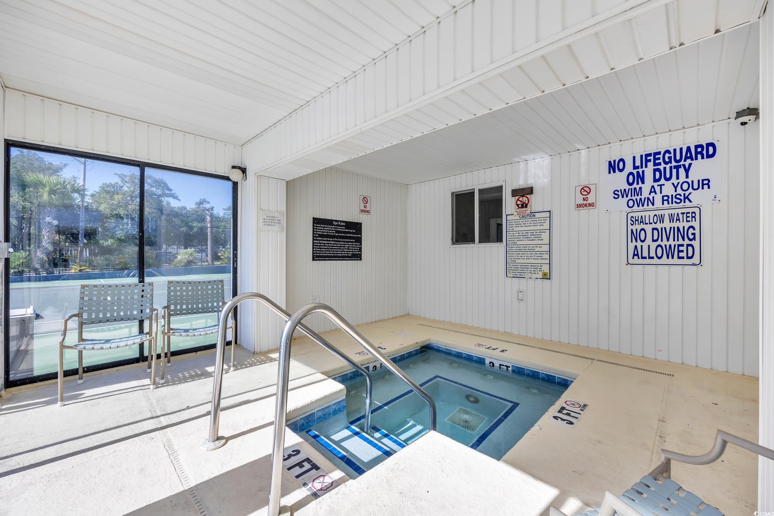 601 Mitchell Drive, Unit 203 Myrtle Beach, SC 29577 - Photo 36 of 40 View of pool with an in-ground hot tub