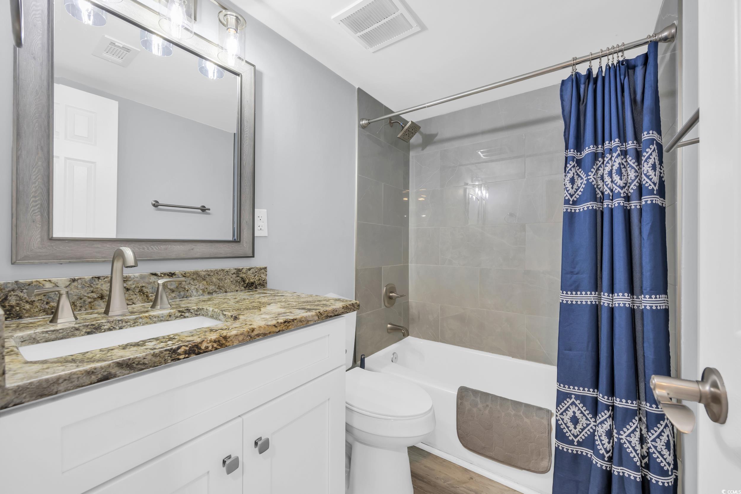 601 Mitchell Drive, Unit 203 Myrtle Beach, SC 29577 - Photo 6 of 40 Full bathroom with shower / bath combination with curtain, vanity, and wood finished floors