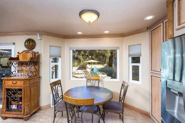 a dining room with furniture and a window
