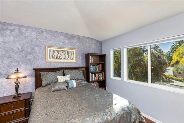 a bedroom with a large bed and a large window