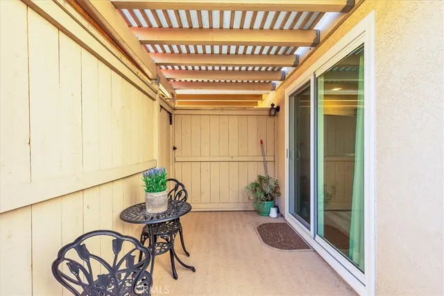 a dining room with furniture and a potted plant