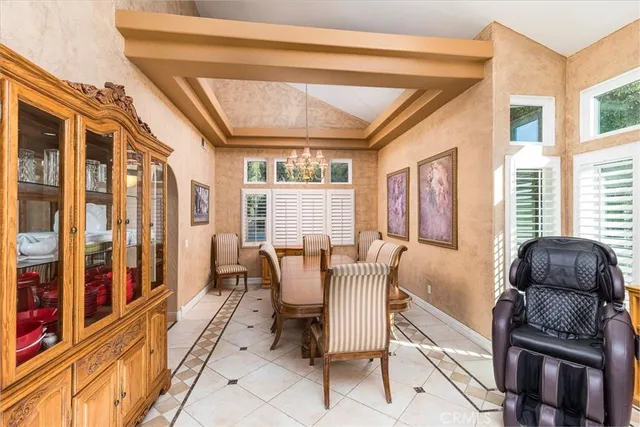 a dining room with furniture and large windows