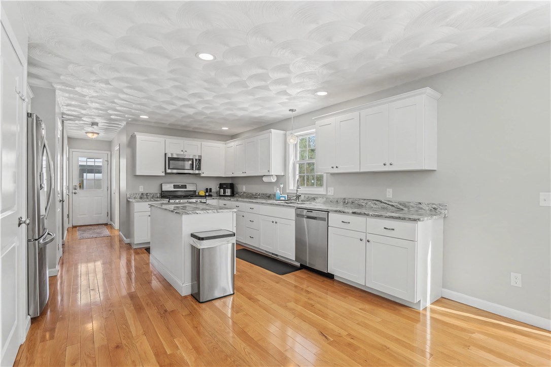 100 Franklin Road Scituate, RI 02825 - Photo 14 of 37 Back door entrance with guest bath, laundry, pantry and garage entrance