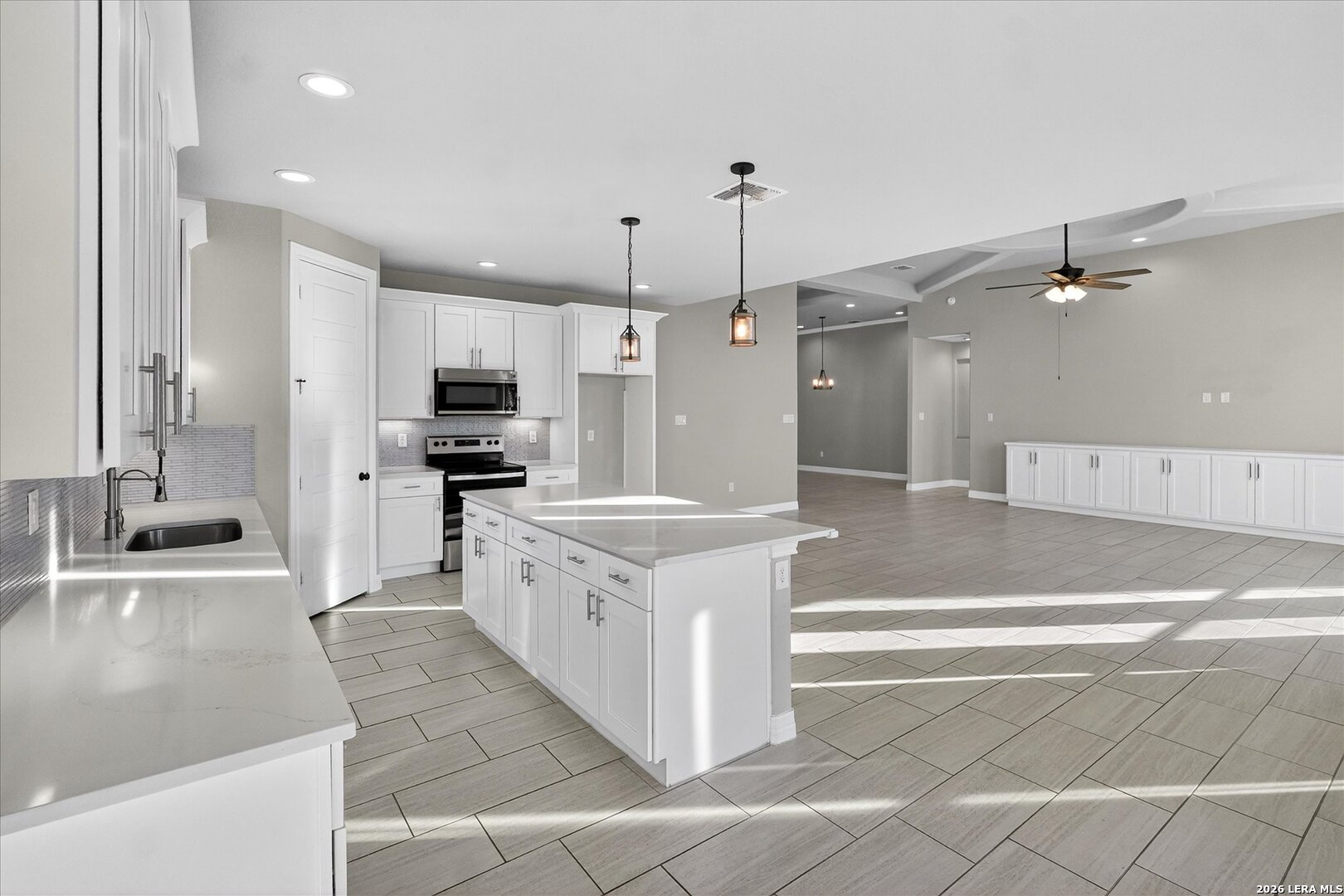 132 West Medium Meadow Drive Lytle, TX 78052 - Photo 13 of 40 a large kitchen with stainless steel appliances kitchen island granite countertop a sink and a stove
