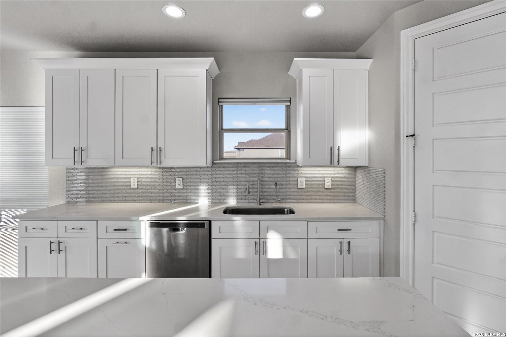 132 West Medium Meadow Drive Lytle, TX 78052 - Photo 14 of 40 a kitchen with stainless steel appliances granite countertop a sink and a stove