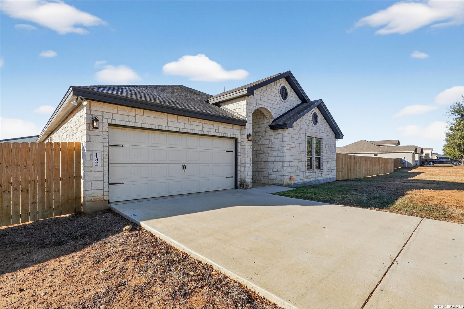132 West Medium Meadow Drive Lytle, TX 78052 - Photo 2 of 40 a front view of a house with a yard and garage
