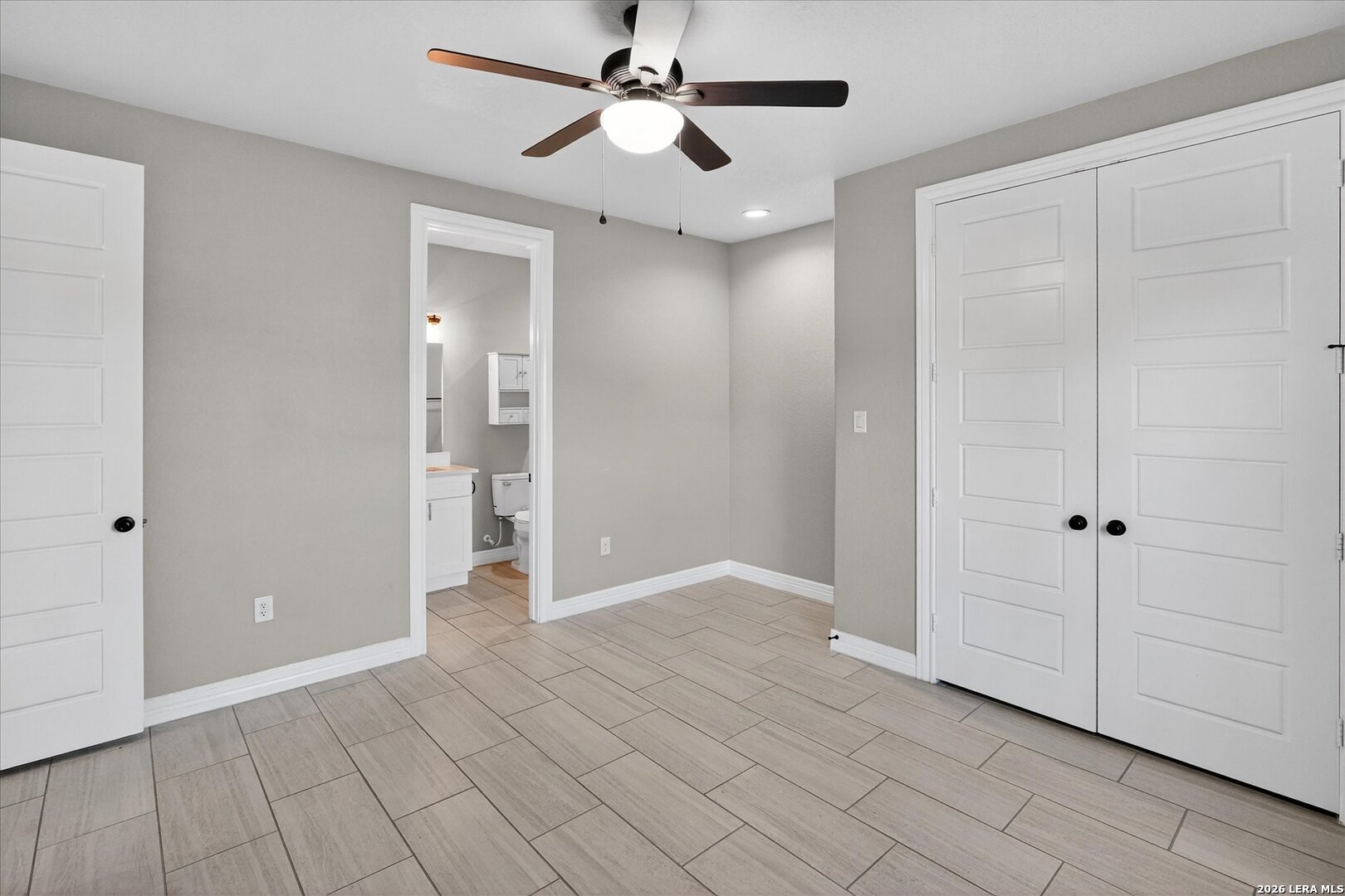 132 West Medium Meadow Drive Lytle, TX 78052 - Photo 28 of 40 wooden floor in an empty room with a bathroom
