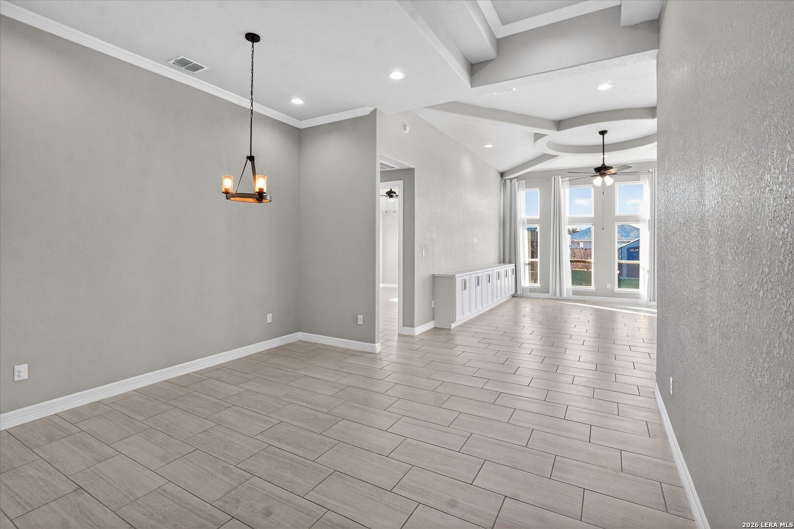 132 West Medium Meadow Drive Lytle, TX 78052 - Photo 8 of 40 an empty room with wooden floor and windows