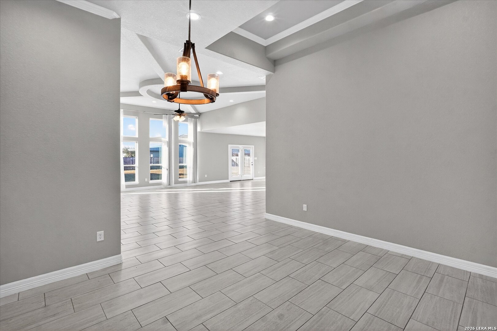 132 West Medium Meadow Drive Lytle, TX 78052 - Photo 9 of 40 a room with wooden floor chandelier and windows