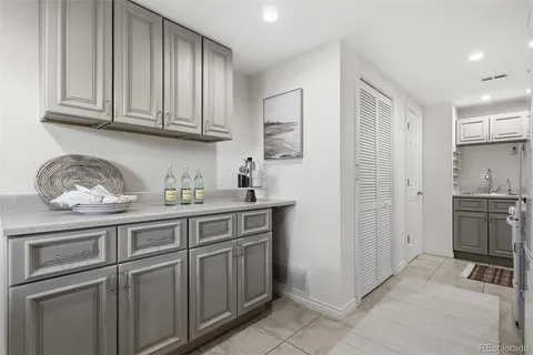 a kitchen with cabinets and chairs