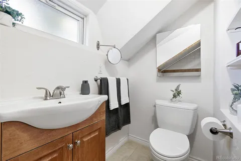 a bathroom with a sink mirror vanity and toilet