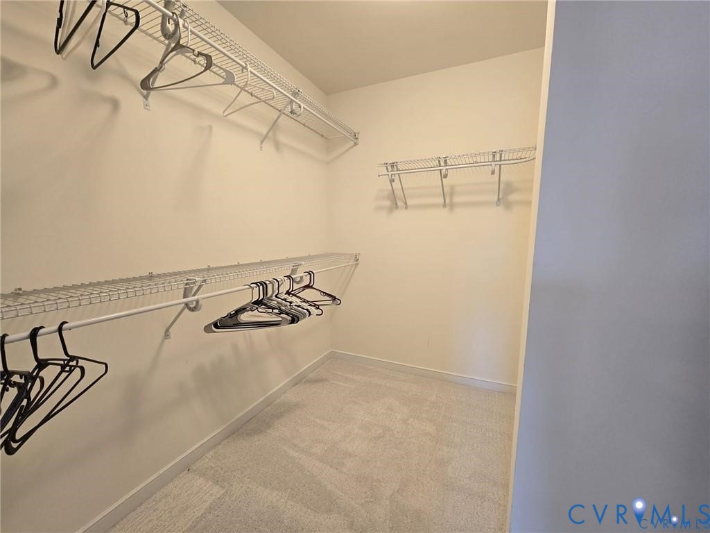 7825 Old Guild Road Richmond, VA 23237 - Photo 22 of 27 Walk-in closet featuring light-toned carpeting and