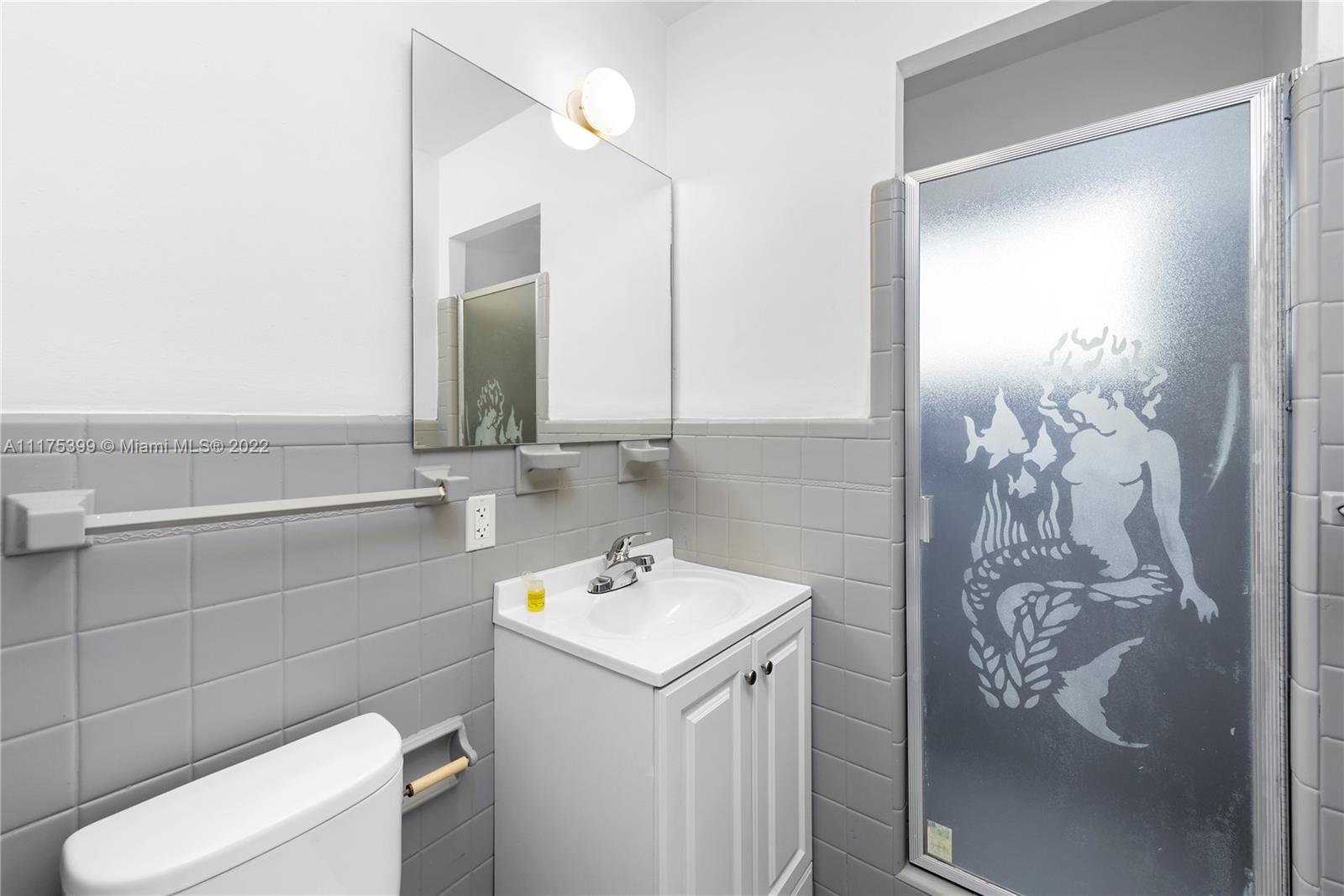 1275 North Biscayne Point Road Miami Beach, FL 33141 - Photo 30 of 39 a bathroom with a sink toilet and mirror