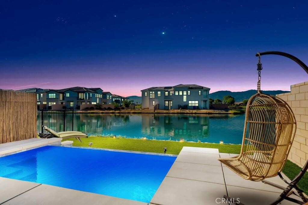 84675 Lago Brezza Indio, CA 92203 - Photo 38 of 40 a view of a lake with a table and chairs