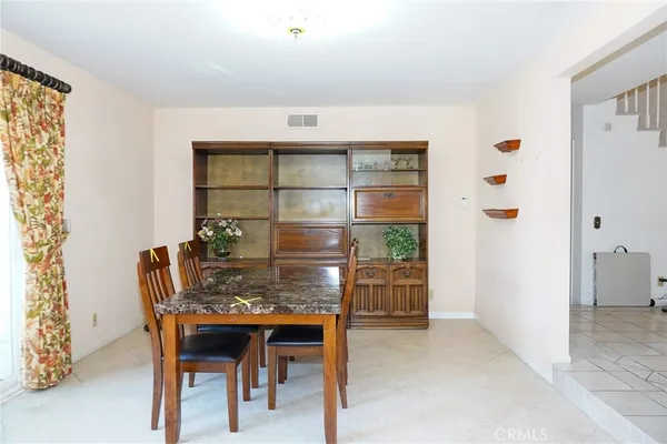 a dining room with furniture and window
