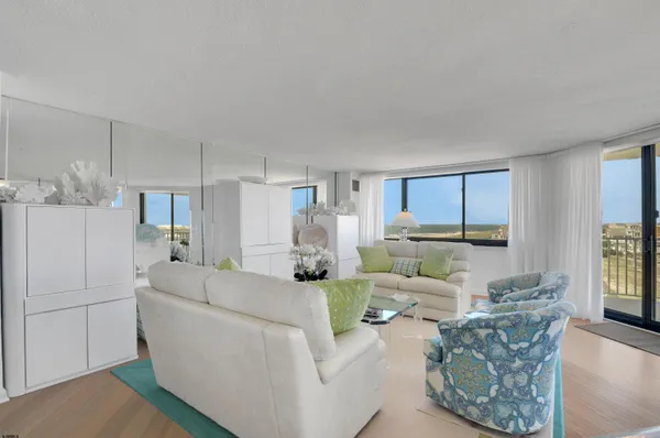 a living room with furniture and large windows