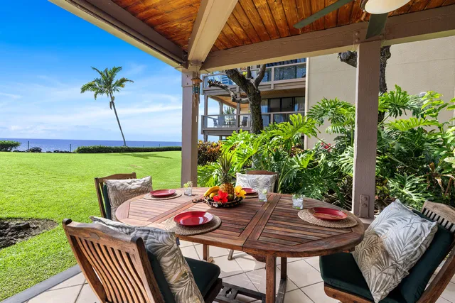 a view of a patio with a table chairs and a potted plant