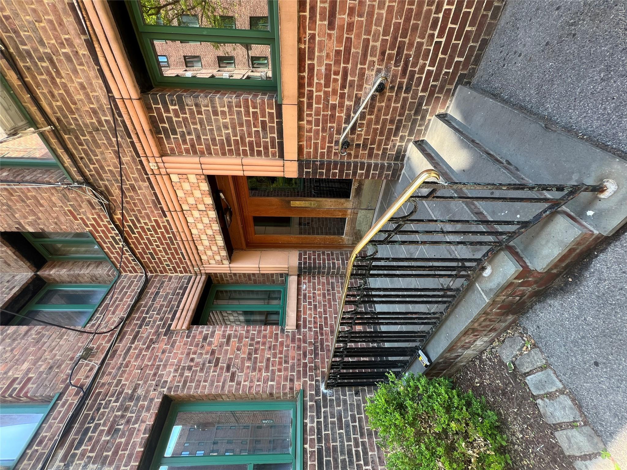 1503 Metropolitan Avenue, Unit 4F Bronx, NY 10462 - Photo 1 of 7 a view of a brick house with a small porch
