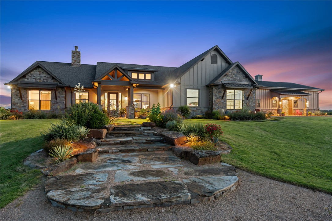 a front view of a house with garden