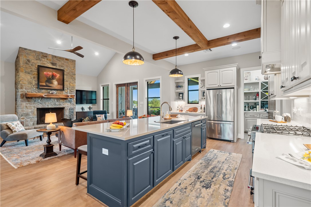 30163 High Spirit Ranch Road Hempstead, TX 77445 - Photo 13 of 49 Kitchen featuring white cabinets, recessed lighting, light countertops, blue cabinetry, and light wood-type flooring