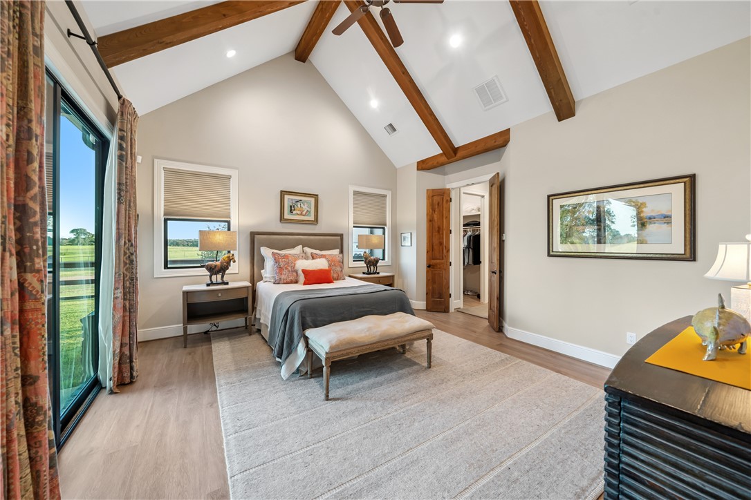 30163 High Spirit Ranch Road Hempstead, TX 77445 - Photo 20 of 49 Bedroom with beam ceiling, high vaulted ceiling, light wood-style flooring, a ceiling fan, and recessed lighting
