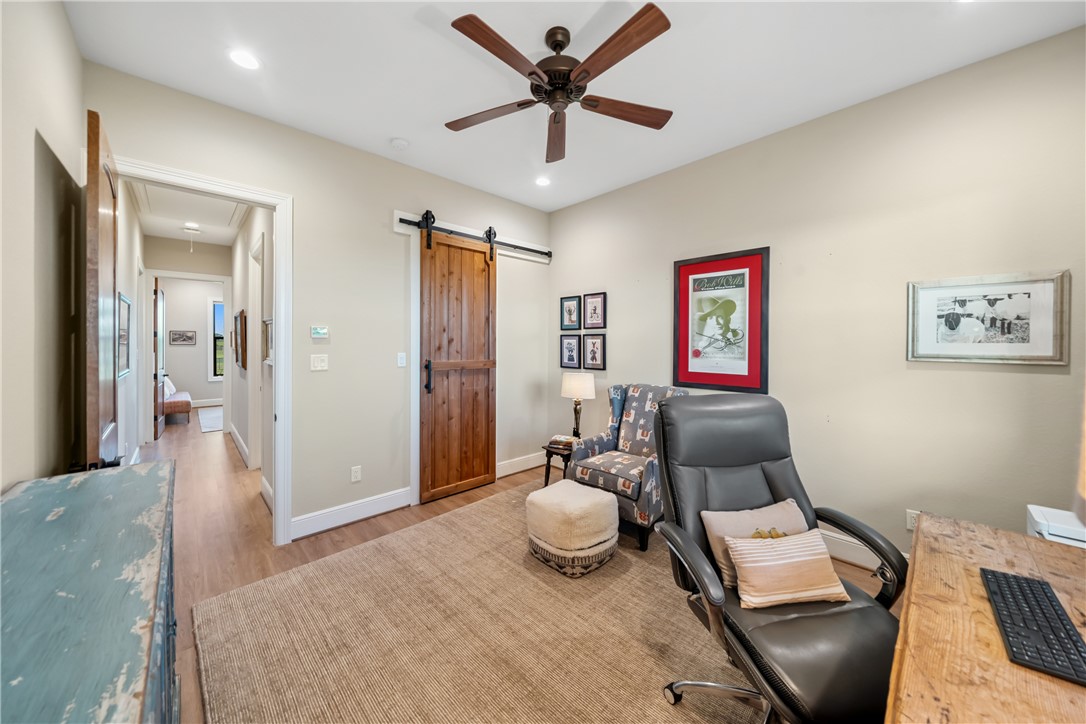 30163 High Spirit Ranch Road Hempstead, TX 77445 - Photo 32 of 49 Home office with recessed lighting, a ceiling fan, wood finished floors, a barn door, and attic access