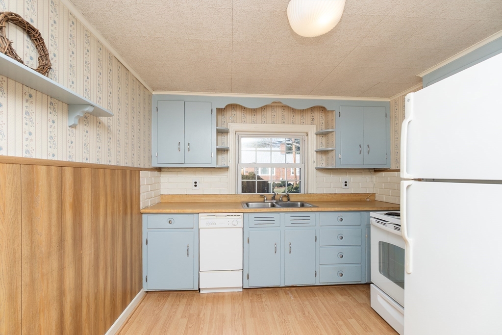 20 Rosedale Road Watertown, MA 02472 - Photo 4 of 21 a kitchen with a sink a stove and cabinets