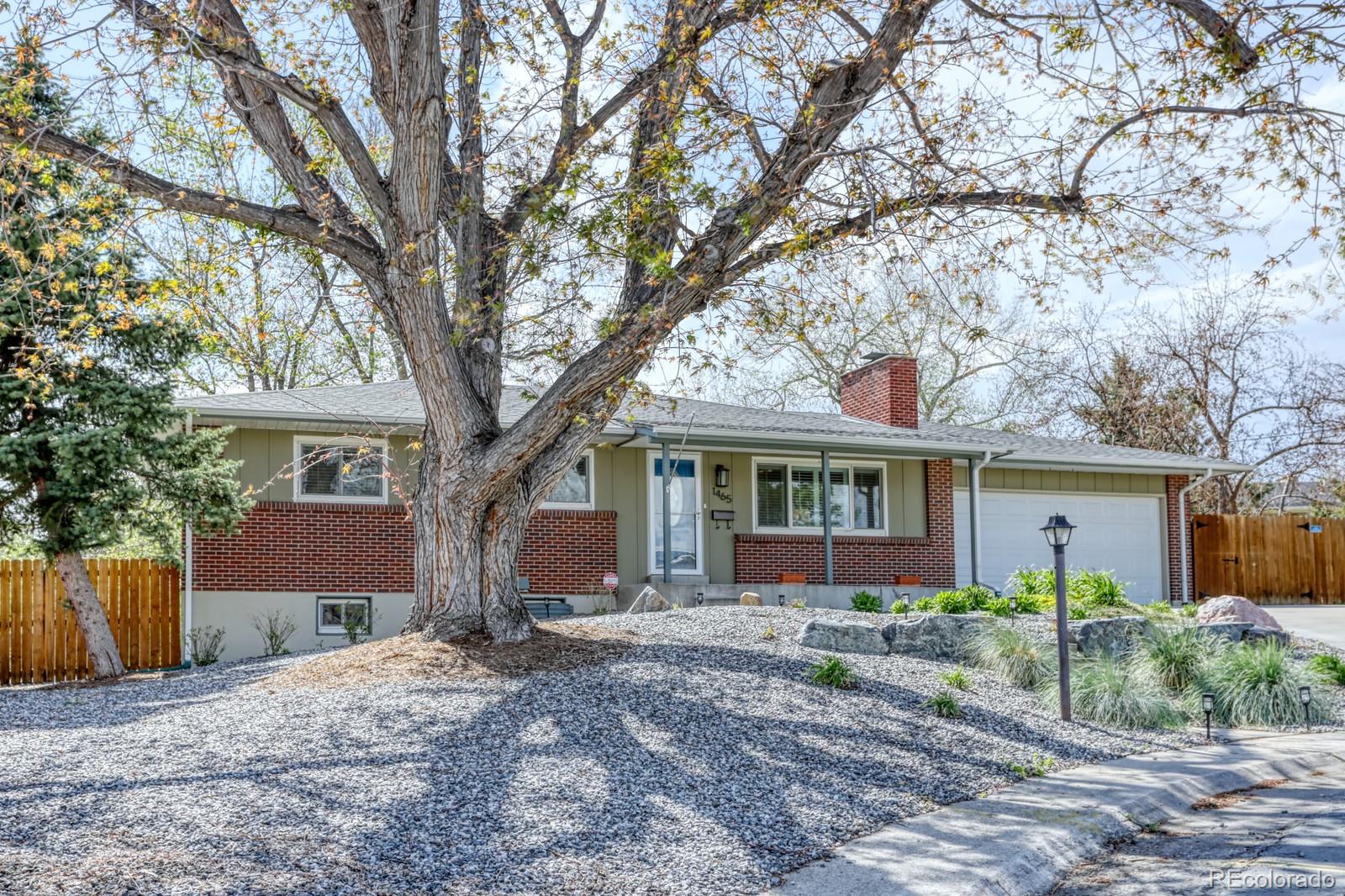 1465 South Vancouver Court Lakewood, CO 80228 - Photo 3 of 31 a front view of house with yard and trees around