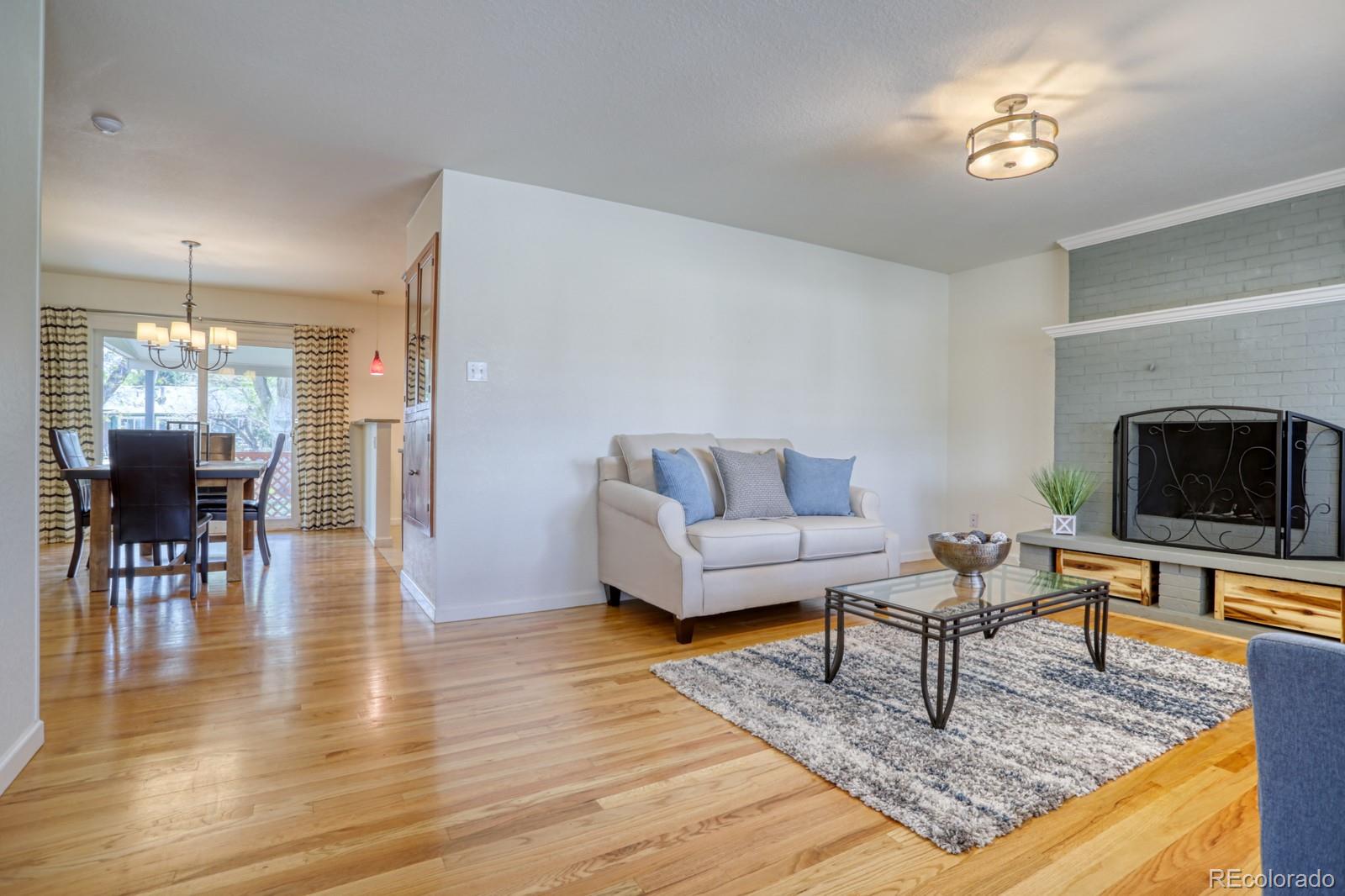 1465 South Vancouver Court Lakewood, CO 80228 - Photo 5 of 31 a living room with furniture and a fireplace
