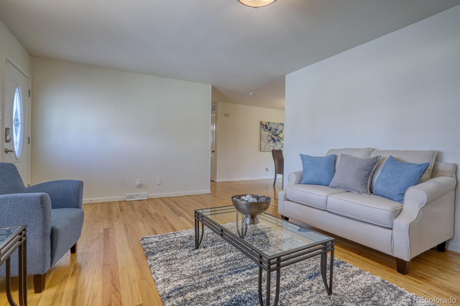 1465 South Vancouver Court Lakewood, CO 80228 - Photo 7 of 31 a living room with furniture and wooden floor