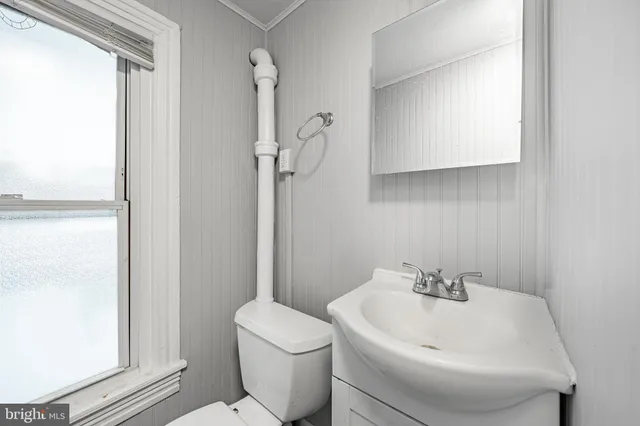 a white toilet sitting next to a bathroom sink