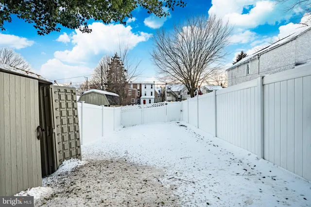 a view of a yard covered in snow
