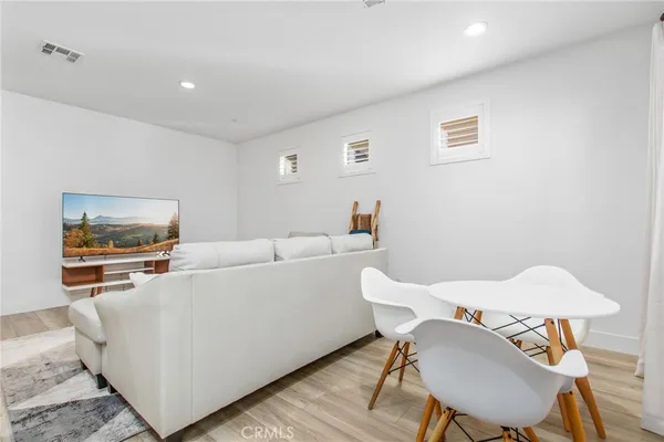 a living room with furniture and kitchen view