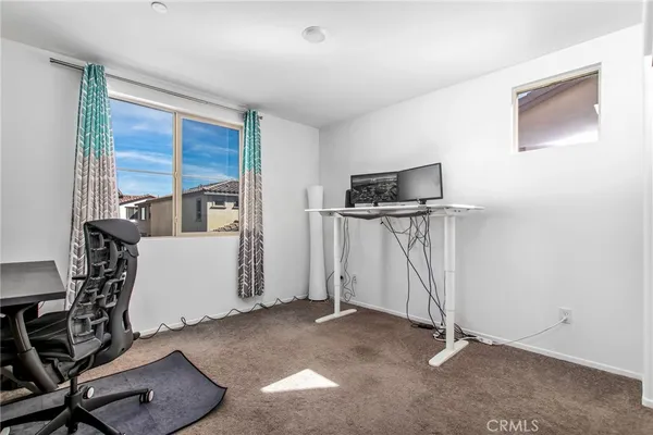 a bedroom with a bed lamp and a window