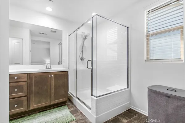 a bathroom with a shower sink and mirror