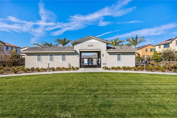 a view of a swimming pool with a lounge chair and palm trees