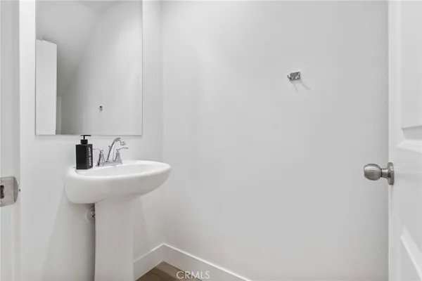 a living room with furniture a large window and a wooden floor