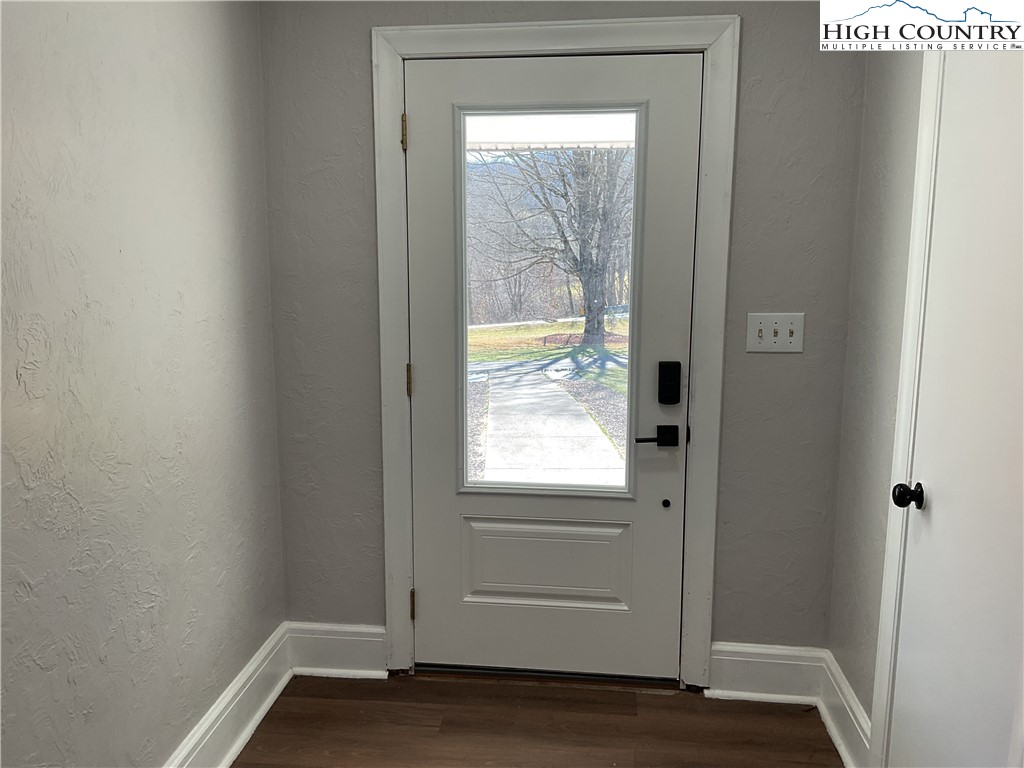 4560 Highway 18 Sparta, NC 28675 - Photo 15 of 43 a view of an empty room with wooden floor and a window