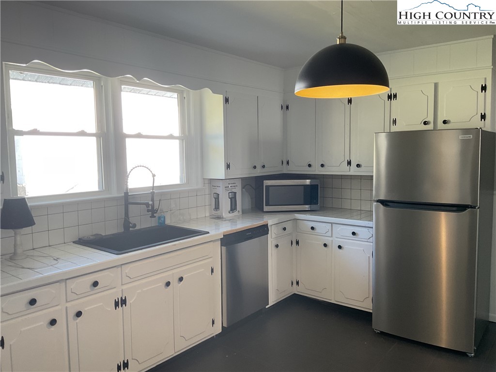 4560 Highway 18 Sparta, NC 28675 - Photo 18 of 43 a kitchen with stainless steel appliances granite countertop a refrigerator a sink dishwasher a stove and a sink