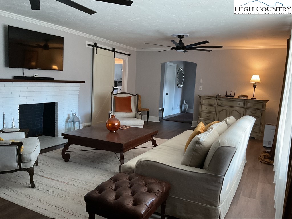 4560 Highway 18 Sparta, NC 28675 - Photo 24 of 43 a living room with furniture a flat screen tv and a fireplace