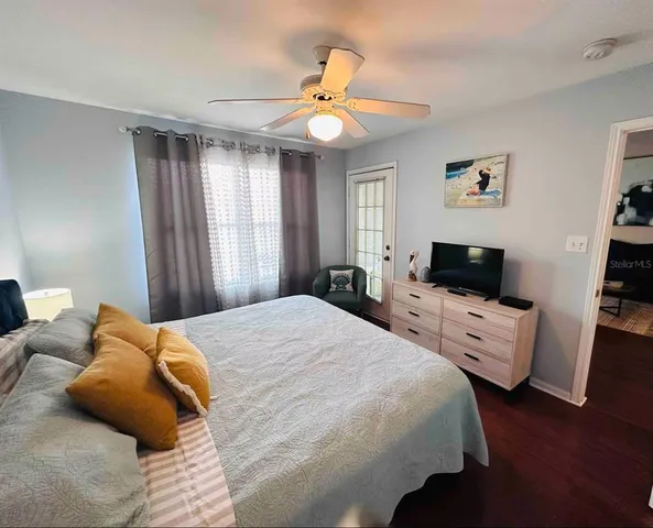 a bedroom with a bed and a flat screen tv