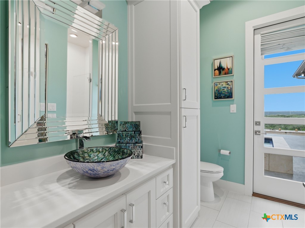 5913 Verden Ridge New Braunfels, TX 78132 - Photo 37 of 48 a view of bathroom with a potted plant on a sink and a toilet