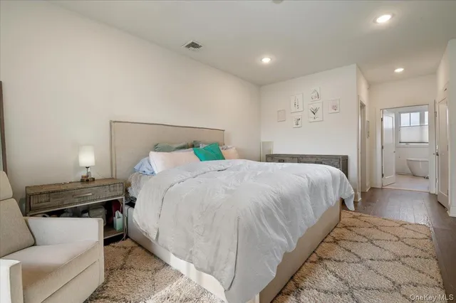 a bedroom with a bed and a couch