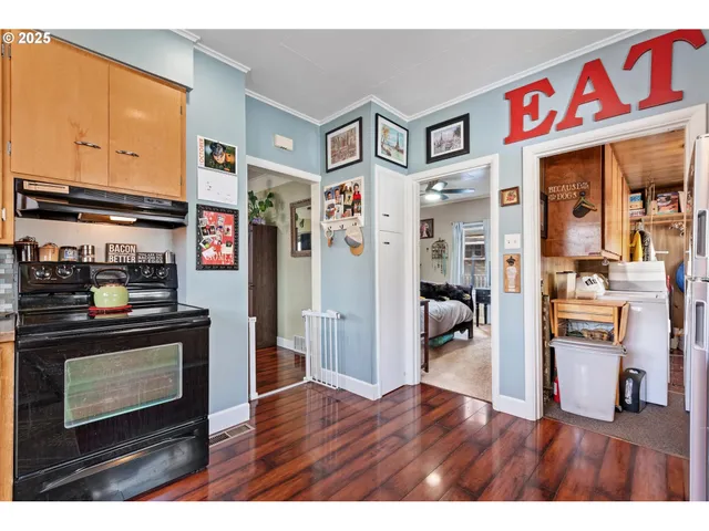 a kitchen view with stainless steel appliances granite countertop a refrigerator and a stove