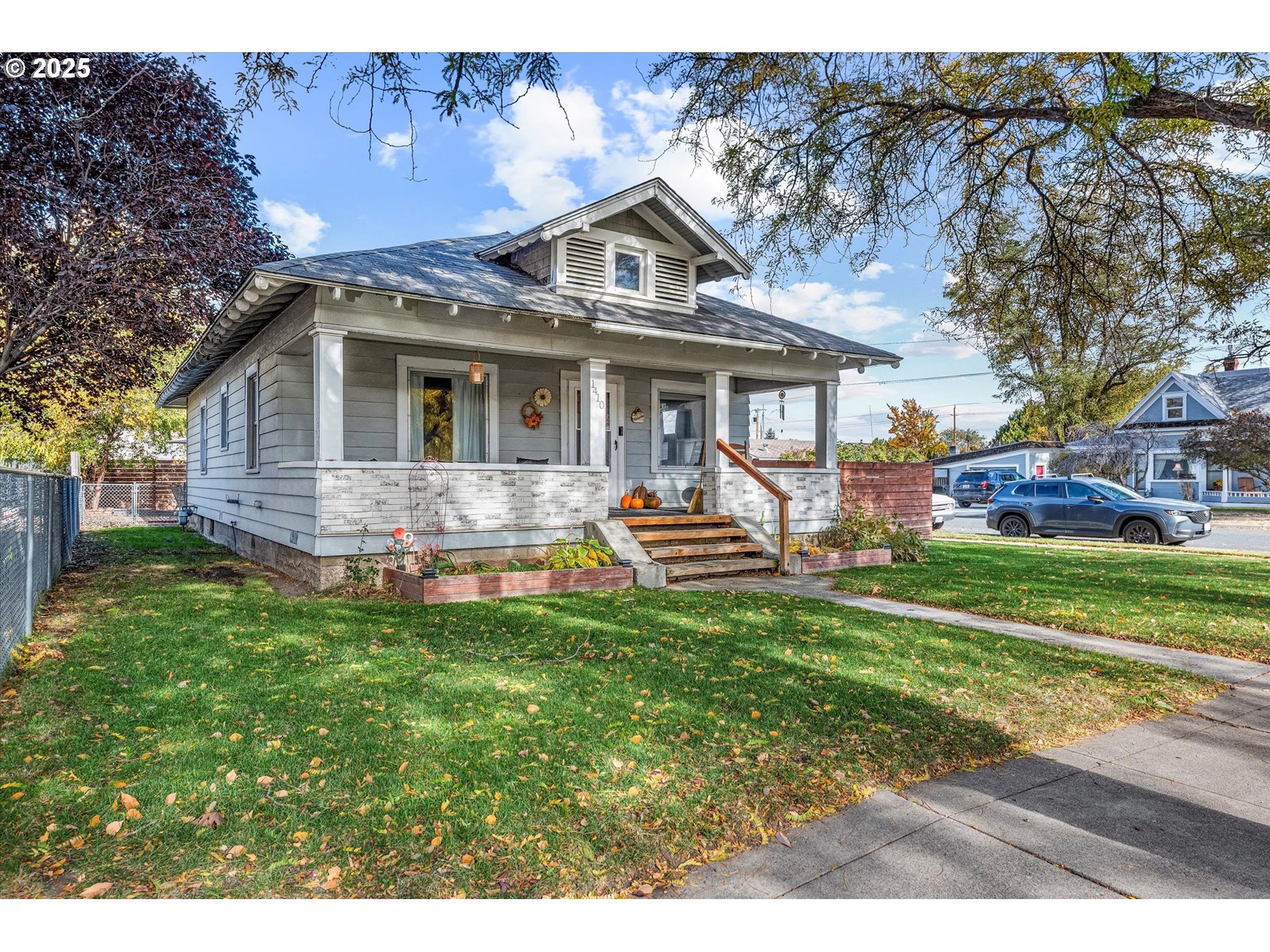 1410 Valley Avenue Baker City, OR 97814 - Photo 2 of 28 a front view of a house with a garden and trees