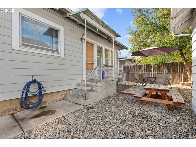 a backyard of a house with barbeque oven
