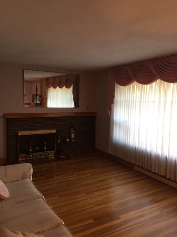 6 Edward Street Canton, MA 02021 - Photo 4 of 16 a living room with furniture and a fireplace