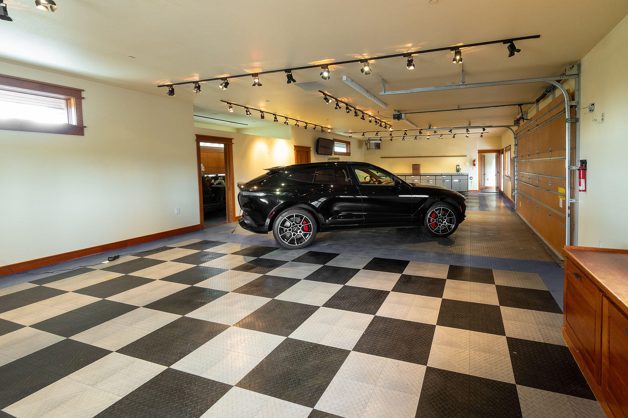 18883 Sutherland Court Bend, OR 97702 - Photo 59 of 70 High-end lighting and epoxy floors elevate this garage beyond the ordinary.