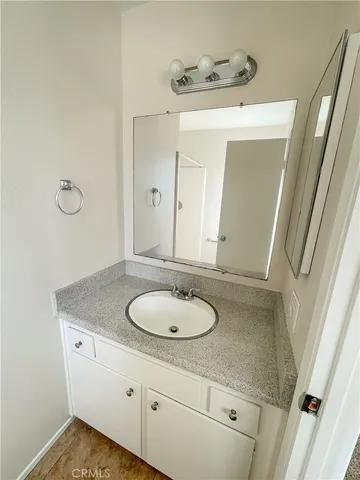 an empty room with a wooden door and glass door